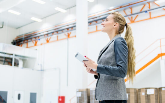 Businesswoman standing at a modern warehouse